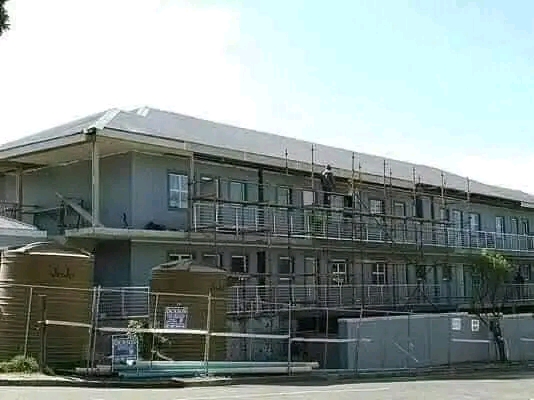 Large building under construction with scaffolding